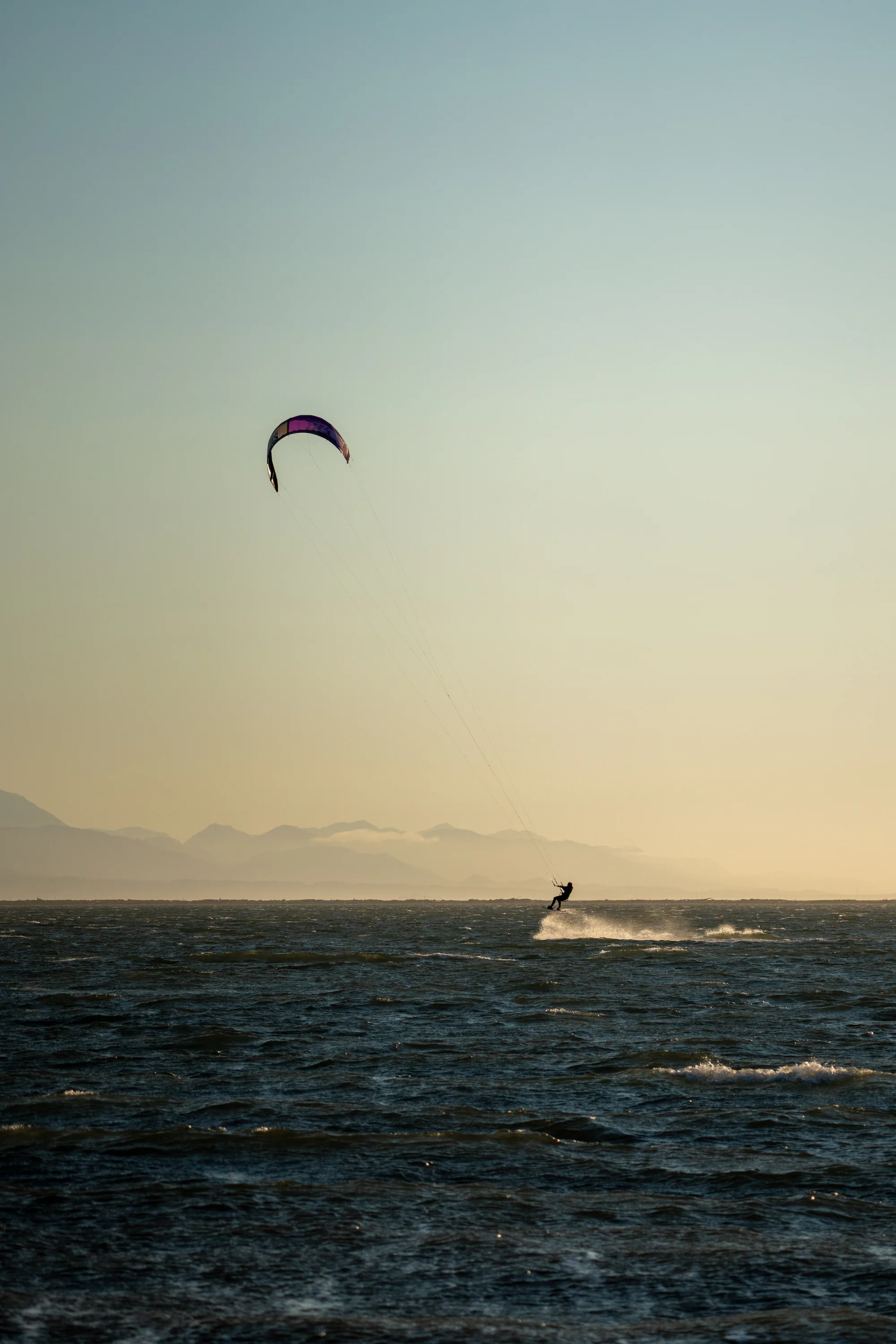 kite surfing jump in the sea at sunset