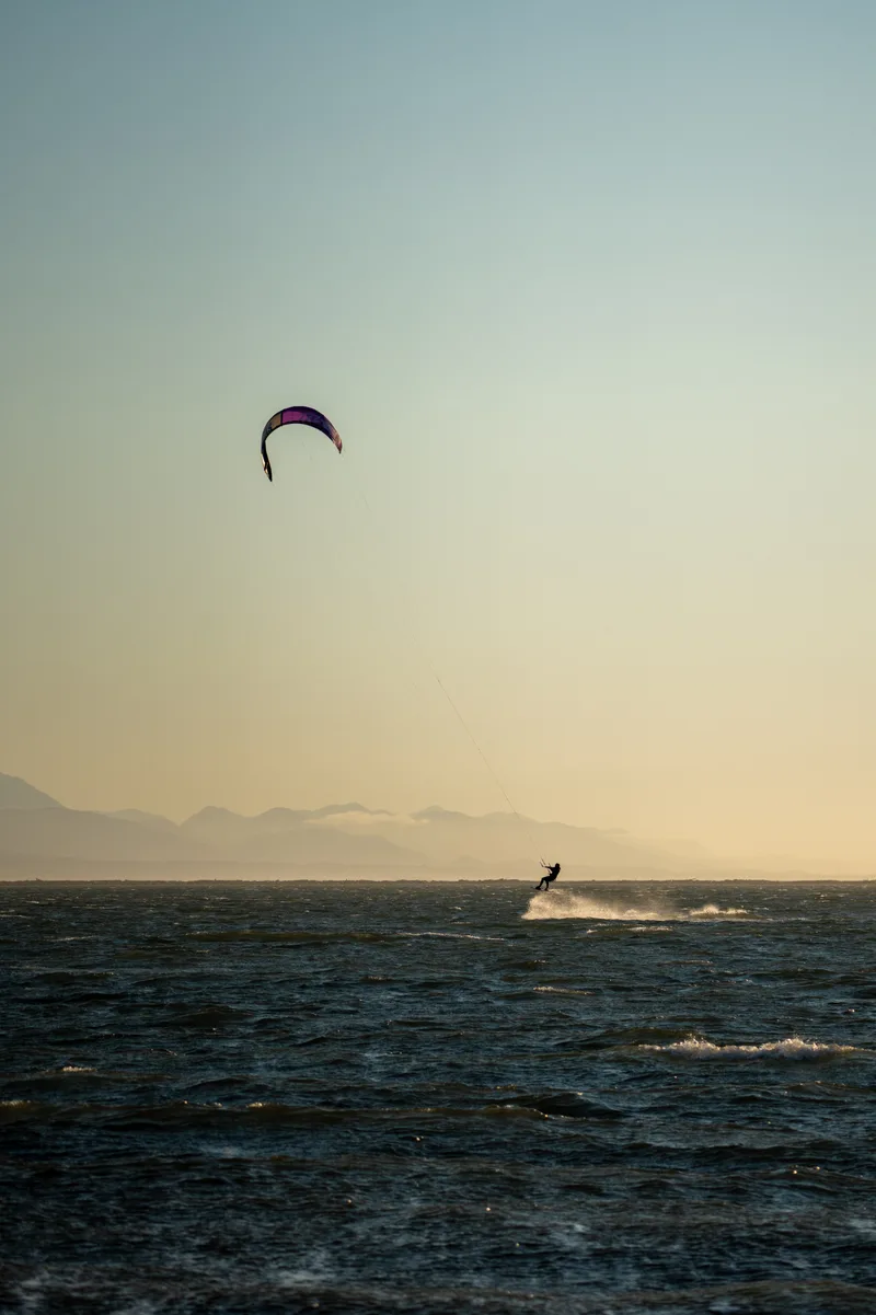 kite surfing jump in the sea at sunset