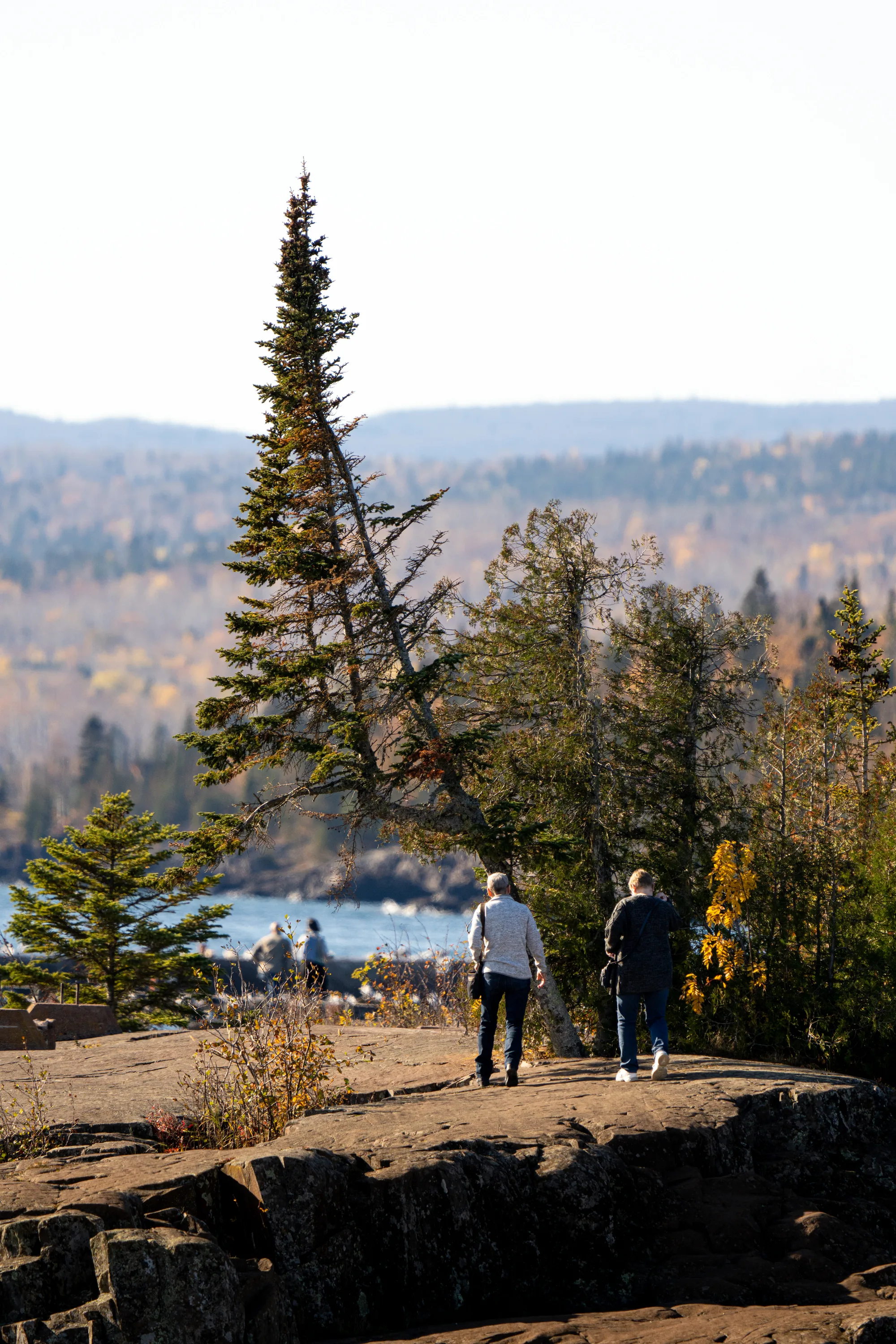 people walking on the breakwater in grand marais minnesota