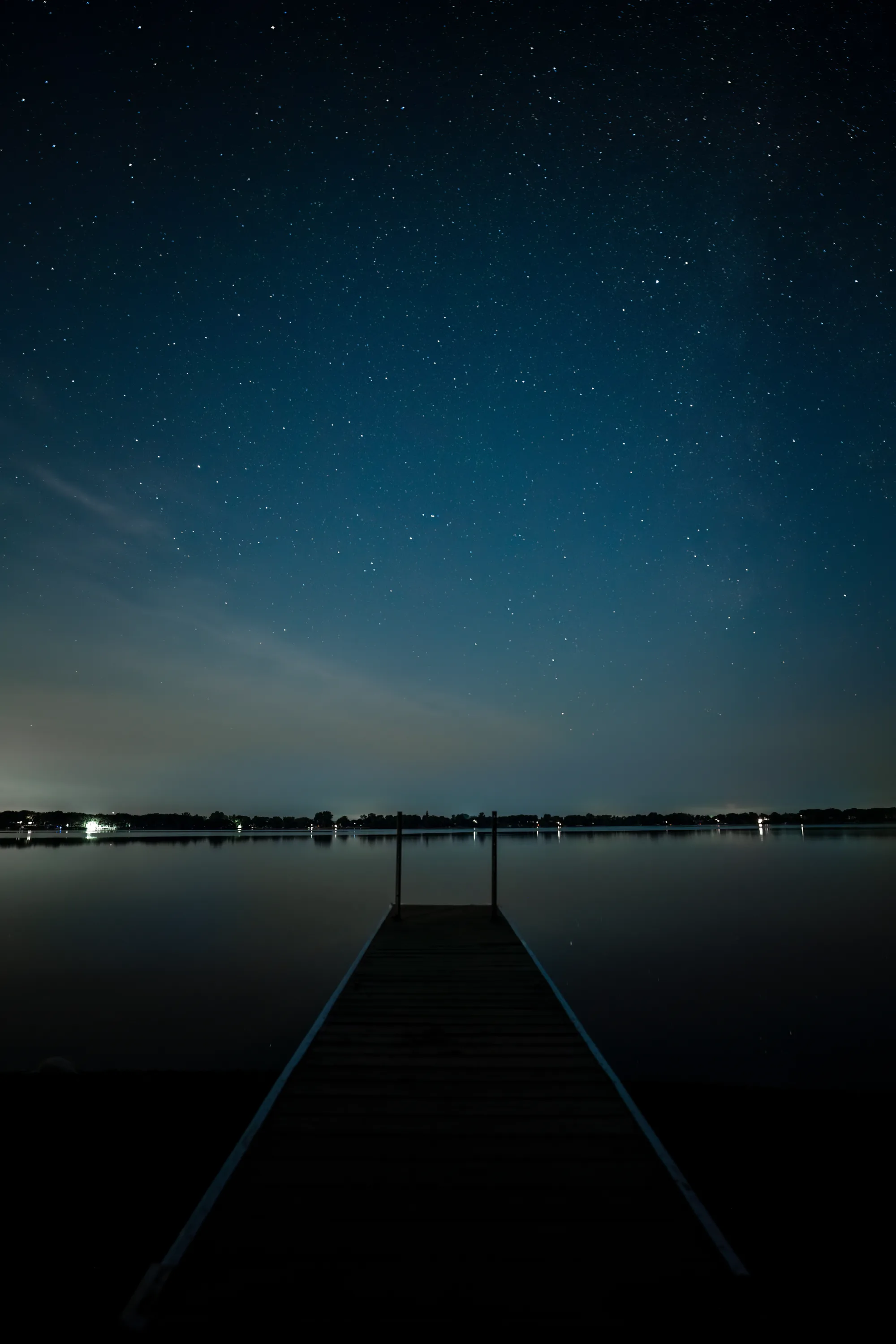 lake side pier at night with the a clear stary sky
