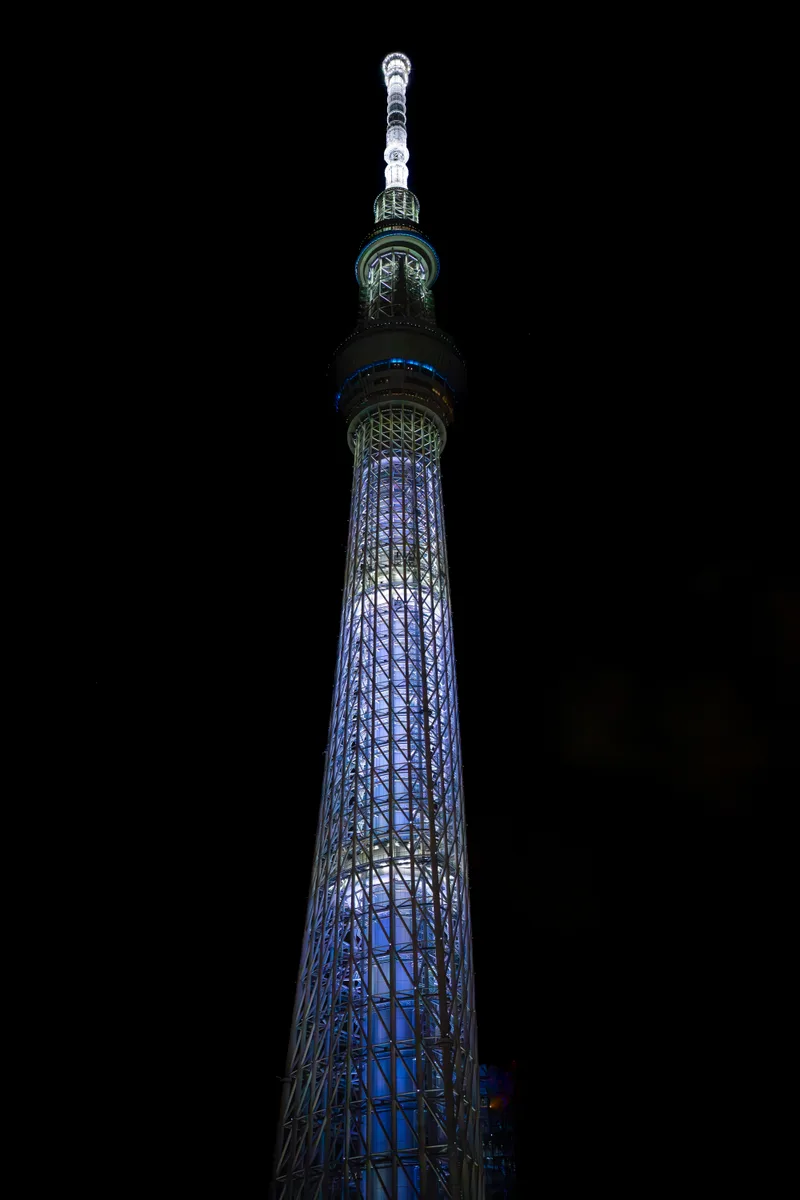 tokyo skytree tree lit up at night in the colors blue and white