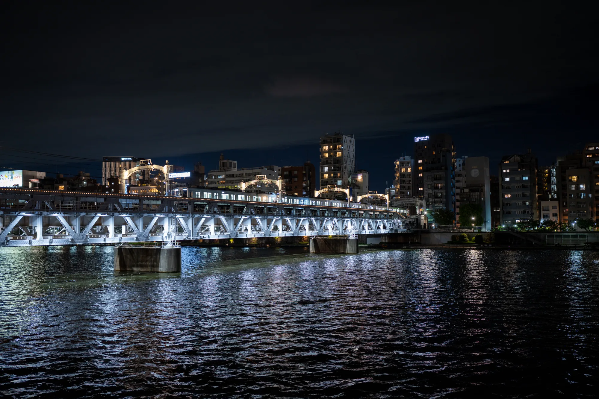 train bridge over the sumida river in tokyo japan at night