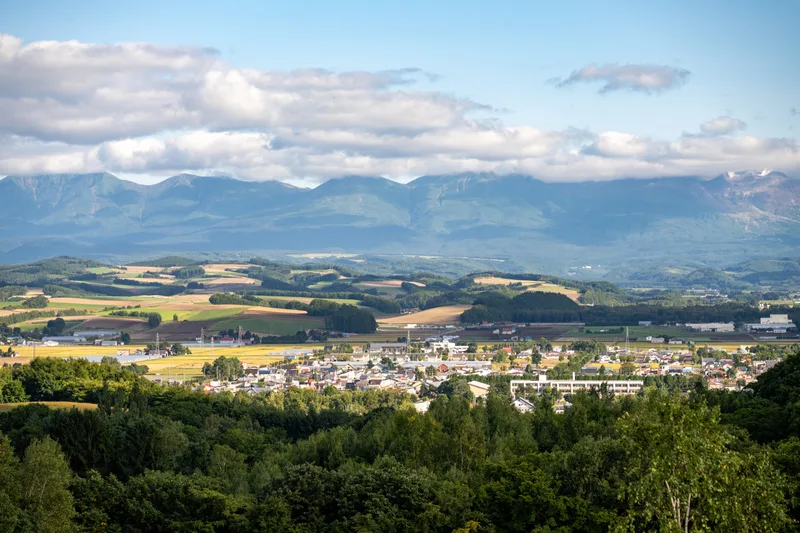 view across the valley that biei japan is nestled in towards the daisetsuzan national park